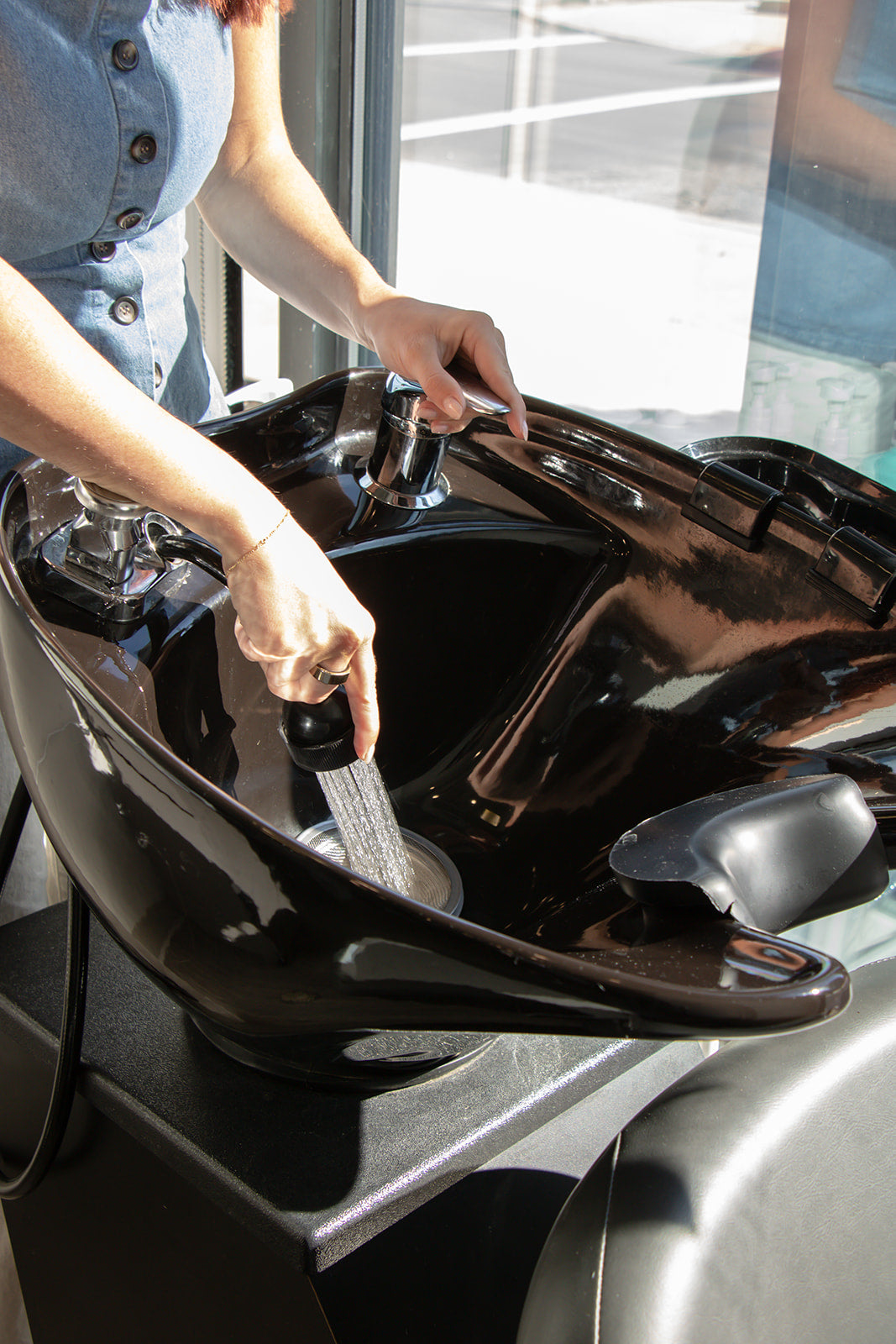 Preparing to shampoo client at Columbus based salon, Poiema Salon